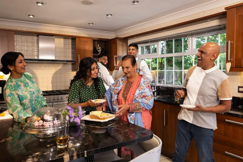 Founding family gathered in a kitchen while trying Super Family beta